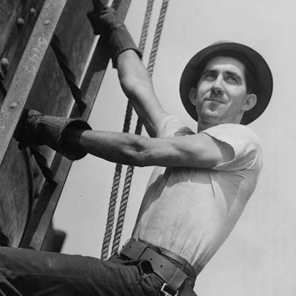 Blue collar worker climbing a ladder.